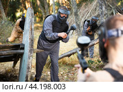Man aiming with paintball market on battleground. Стоковое фото, фотограф Яков Филимонов / Фотобанк Лори