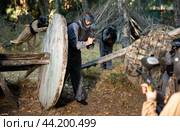 Impudent teams facing on battlefield in outdoor paintball arena during match. Стоковое фото, фотограф Яков Филимонов / Фотобанк Лори