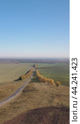 Vertical video of country road and agricultural fields after harvest at autumn time. Altai Krai. Camera moves sideways. Стоковое видео, видеограф Сергей Пристяжнюк (Serg Zastavkin) / Фотобанк Лори