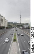 Car traffic on Dostyk Avenue against the backdrop of Mount Kok-Tobe and the city tower. Kazakhstan. Alama-ata. 24.08.2024. Редакционное видео, видеограф Ярославский Максим / Фотобанк Лори