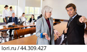 Angry businessman dismissing sad senior woman. Стоковое фото, фотограф Яков Филимонов / Фотобанк Лори