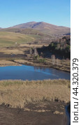 Vertical video of flying over a hilly rural landscape with fish ponds in Altai Krai. Стоковое видео, видеограф Сергей Пристяжнюк (Serg Zastavkin) / Фотобанк Лори