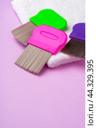 Three combs for removing lice and nits on lilac background. Стоковое фото, фотограф Сергей Толмачёв / Фотобанк Лори
