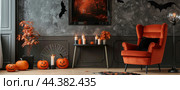 Cozy Halloween Living Room Decor With Jack OLanterns, Bats, and Candles. Стоковое AI-изображение, AI-художник Юлия Гапеенко / Фотобанк Лори