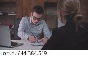 Young adult man answering questions during job interview. Стоковое видео, видеограф Константин Шишкин / Фотобанк Лори