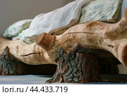 Rustic wooden bed frame with natureinspired design. Стоковое AI-изображение, AI-художник Иван Рябоконь / Фотобанк Лори