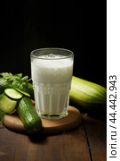 Glass of milk with fresh cucumber. Стоковое AI-изображение, AI-художник Veniamin Kraskov / Фотобанк Лори