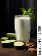 Glass of milk with fresh cucumber. Стоковое AI-изображение, AI-художник Veniamin Kraskov / Фотобанк Лори