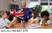 at evening geography lesson, elderly teacher tells attentive students about Australia. Стоковое видео, видеограф Яков Филимонов / Фотобанк Лори