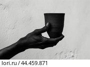 Sturdy Black hand holding coffee cup. Generate ai. Стоковое AI-изображение, AI-художник Иван Рябоконь / Фотобанк Лори