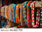 Colorful beaded bracelets display at market stall. Стоковое AI-изображение, AI-художник Иван Рябоконь / Фотобанк Лори