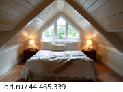 Cozy attic bedroom with natural light. Стоковое AI-изображение, AI-художник Иван Рябоконь / Фотобанк Лори