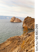 Baikal Lake on October. View of rocky coast of Olkhon Island in Khuzhir village. Famous Shamanka Rock - natural landmark of lake. Scenic autumn landscape on sunset. Natural background. Стоковое фото, фотограф Виктория Катьянова / Фотобанк Лори