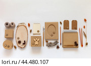 DIY concept. Natural materials for craft. Set of supplies for making and packaging handmade gifts for Christmas or Thanksgiving: kraft paper boxes, frame, pencils on white background. Flat lay, copy space. Стоковое фото, фотограф Виктория Катьянова / Фотобанк Лори