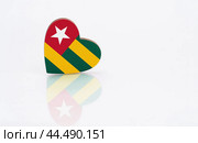 Flag of Togo in the shape of a heart on a white background. The concept of patriotism. copyspace. Стоковое фото, фотограф Никита Бурденков / Фотобанк Лори