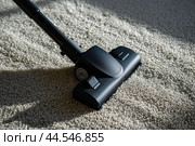 Vacuum cleaner head on carpeted floor. Стоковое AI-изображение, AI-художник Иван Рябоконь / Фотобанк Лори