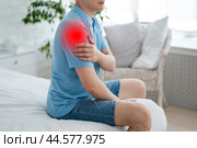 Dislocation of the shoulder, joint inflammation, arthritis and degenerative changes, man with pain in hand at home. Стоковое фото, фотограф Станислав Тарко / Фотобанк Лори