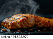 Hot smoked salmon fillet on a black board. Hot lox piece with steamed smoke. Dark background. Salmon steak served lemon, herbs cooking grill barbecue. Grilled red fish dish. Frying trout. Menu, recipe. Стоковое AI-изображение, AI-художник Марина Демидюк / Фотобанк Лори