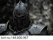 Medieval knight in armor amidst snowfall. Стоковое AI-изображение, AI-художник Иван Рябоконь / Фотобанк Лори