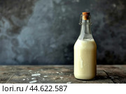 Fresh milk in glass bottle on wooden surface. Стоковое AI-изображение, AI-художник Иван Рябоконь / Фотобанк Лори
