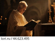 Serene priest reading holy book in church. Стоковое AI-изображение, AI-художник Иван Рябоконь / Фотобанк Лори