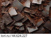 Dark chocolate shavings and chunks texture. Стоковое AI-изображение, AI-художник Иван Рябоконь / Фотобанк Лори