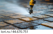 Cleaning process of outdoor paving stones with a high-pressure water jet in a residential area during daylight. Стоковое AI-изображение, AI-художник Сергей Толмачёв / Фотобанк Лори