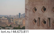 Close-up shot of decorative elements within an old, abandoned concrete structure, set against the backdrop of the urban landscape. Стоковое видео, видеограф Strunov David / Фотобанк Лори