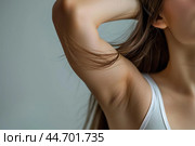 Young woman showing armpit hair and underarm with scars. Стоковое AI-изображение, AI-художник Иван Рябоконь / Фотобанк Лори