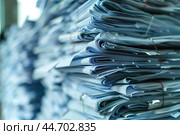 Stack of paperwork representing administrative burden. Стоковое AI-изображение, AI-художник Иван Рябоконь / Фотобанк Лори