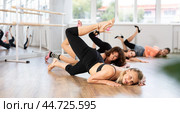 Female dancer mastering floorwork during high heels dance routine. Стоковое фото, фотограф Яков Филимонов / Фотобанк Лори