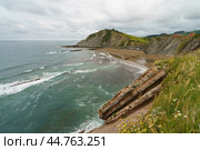 Charming Zumaia Itzurun beach. Steeply-tilted layers of flysch in Zumaia. Atlantic ocean surf in Basque Autonomous Community  in day in Bay of Biscay. View from above / top view. Стоковое фото, фотограф YuryKara / Фотобанк Лори