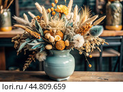 A beautiful bouquet of dried flowers in a ceramic vase on an antique wooden chest of drawers. A bouquet of flowers in a vase in a home interior. Light, beige, blue floral background. Стоковое AI-изображение, AI-художник Photojuli / Фотобанк Лори