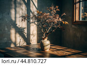 Branches with golden autumn leaves in a ceramic vase on a wooden table by the window. The concept of home comfort. Autumn decor for Halloween. Стоковое AI-изображение, AI-художник Photojuli / Фотобанк Лори
