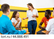 Portrait of delighted girl student with her groupmates and female teacher in auditorium. Стоковое фото, фотограф Яков Филимонов / Фотобанк Лори