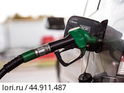 The gas station. Filling the car with gasoline. A Russian fuel dispenser in the fuel tank of a car at a gas station. Rising fuel prices around the world. Стоковое фото, фотограф Photojuli / Фотобанк Лори