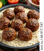 Meatballs are a meat or fish dish, a hot appetizer or a second course. They are balls the size of a walnut to a small apple made of meat or fish cutlet mass or chopped mass mixed with steamed rice. Стоковое AI-изображение, AI-художник Сергей Елизарьев / Фотобанк Лори