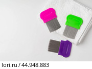 Anti lice combs and towel on white background. Стоковое фото, фотограф Сергей Толмачёв / Фотобанк Лори