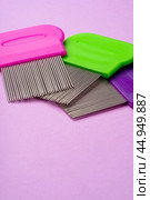 Three combs for removing lice and nits on lilac background. Стоковое фото, фотограф Сергей Толмачёв / Фотобанк Лори