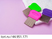 Three combs for removing lice and nits on lilac background. Стоковое фото, фотограф Сергей Толмачёв / Фотобанк Лори