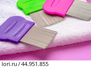 Three combs for removing lice and nits on lilac background. Стоковое фото, фотограф Сергей Толмачёв / Фотобанк Лори