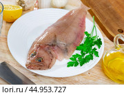 Raw megrim fish served with parsley. Стоковое фото, фотограф Яков Филимонов / Фотобанк Лори