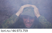 A soldier in a trench during a war under artillery fire. Стоковое видео, видеограф Илья Шаматура / Фотобанк Лори