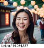 A cheerful Chinese woman dressed in a white blazer smiles warmly while standing in a vibrant traditional courtyard filled with lanterns. People walk by in the background. Mongoloid Asian face type. AI. Стоковое AI-изображение, AI-художник Юлия Петровская / Фотобанк Лори