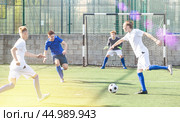 Young football players fighting for ball. Стоковое фото, фотограф Яков Филимонов / Фотобанк Лори