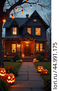 Halloween glowing decor on the facade of the house outside made of pumpkins, garlands, Jack Latern, candles. Halloween party In the evening at dusk. AI generated. Стоковое AI-изображение, AI-художник Ольга Симонова / Фотобанк Лори