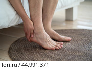 Foot pain, corns and calluses, dry skin on legs, man suffering from feet ache, podiatry concept. Стоковое фото, фотограф Станислав Тарко / Фотобанк Лори