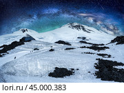 Night trekking and mountain climbing Elbrus, highest mountain in Europe. starry sky and snowy peak. beautiful panorama of mountains against night sky. mountaineering, trekking and mountain climbing. Стоковое фото, фотограф Павел Муравьев / Фотобанк Лори