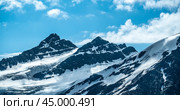Mountain peak of snow-capped mountains, beautiful panorama of mountains. dark high rocks against bright blue sky. mountaineering Panoramic Image. Стоковое фото, фотограф Павел Муравьев / Фотобанк Лори