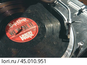 Moscow, Russia - September 13 2019: Photography of modern vinyl turntable with vinyl plate. Listen to music. Close view from above. Редакционное фото, фотограф YuryKara / Фотобанк Лори